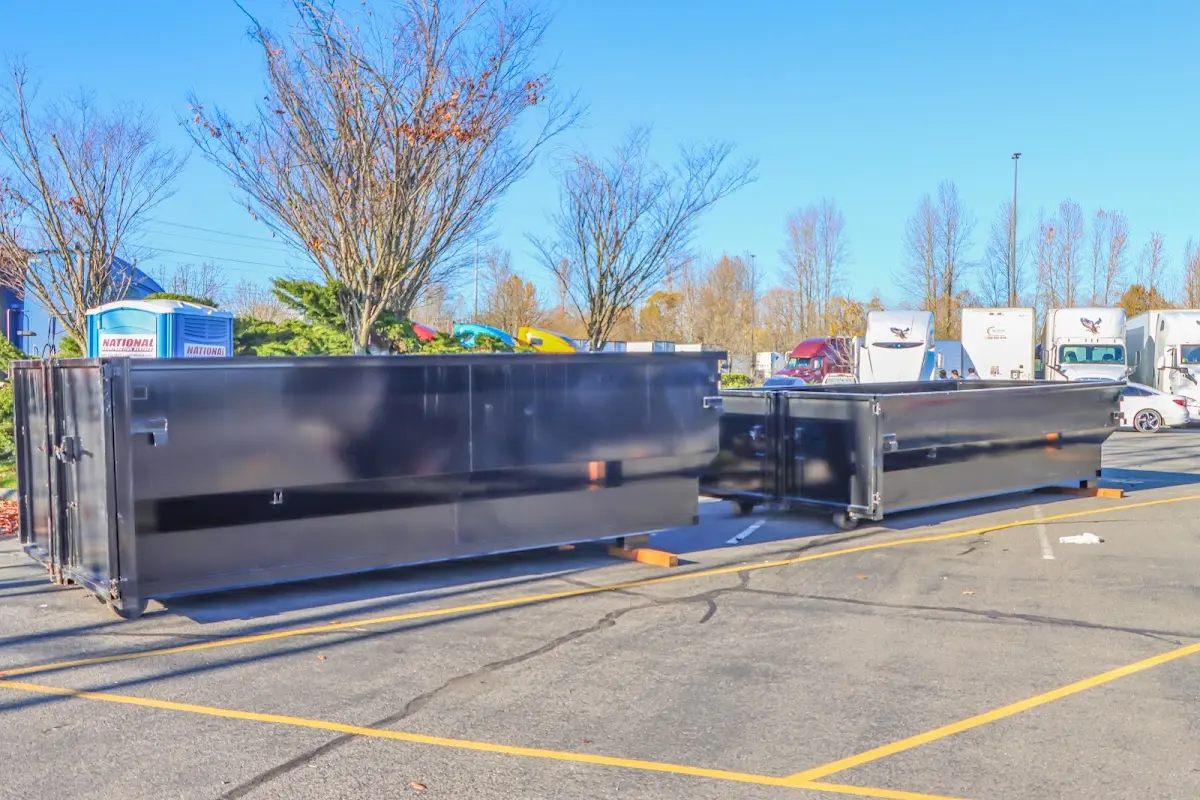 Professional dumpster rental service with roll-off container on residential driveway in Mayo